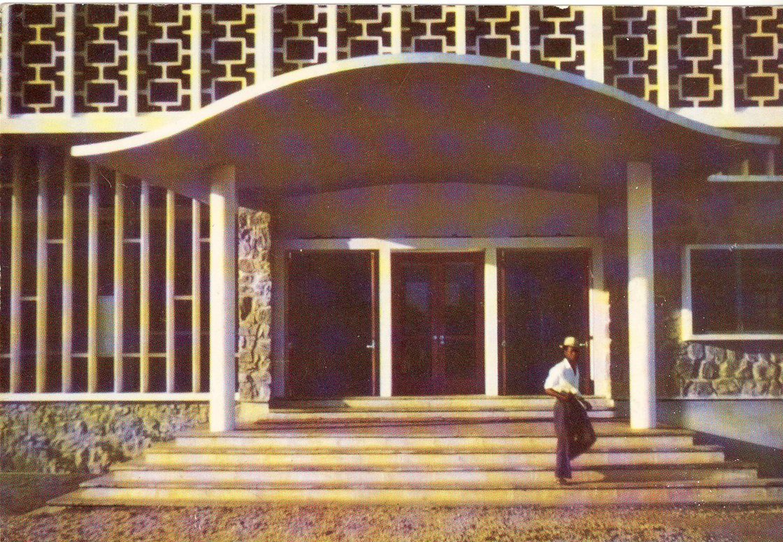 A historical postcard photograph of the Kenneth Dike Library entrance at the University of Ibadan, dated 1960